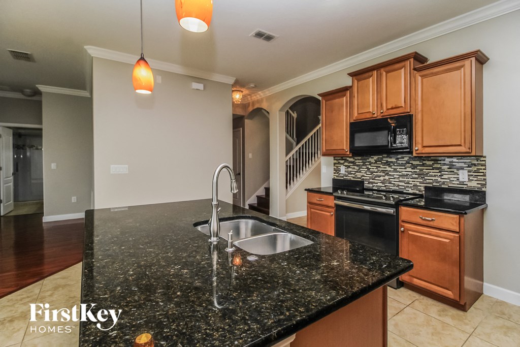 a kitchen with granite counter tops and a sink