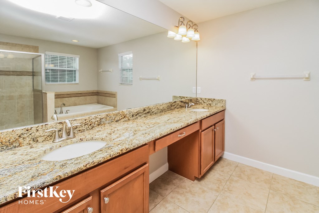 a large bathroom with two sinks and a large mirror