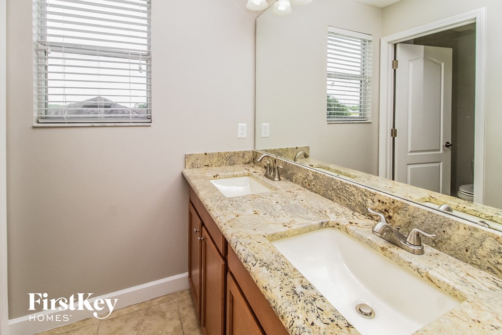 a bathroom with two sinks and a large mirror