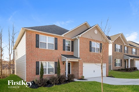 A large brick house with a garage is for sale.