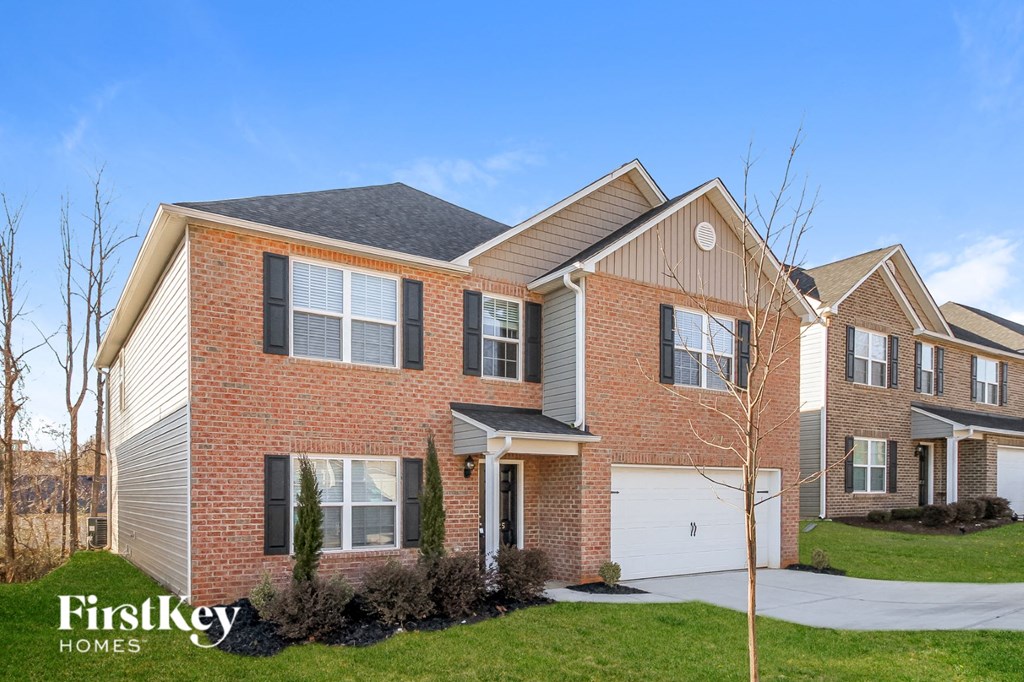 A large brick house with a garage is for sale.