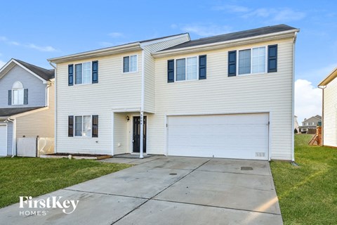 a white house with white siding and a white garage door