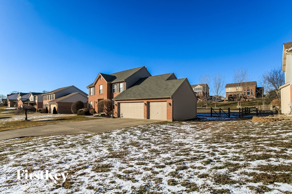 A house with a snowy front yard.