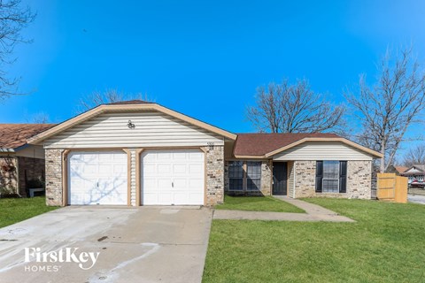 a brick house with a white garage door