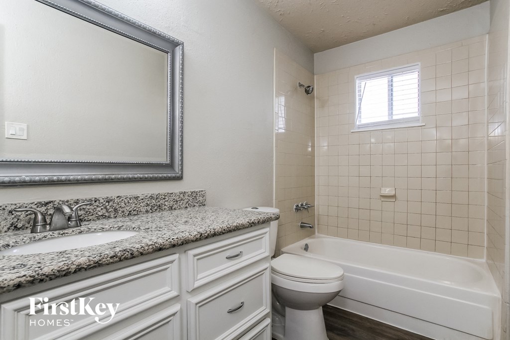 a bathroom with a sink toilet and a bath tub