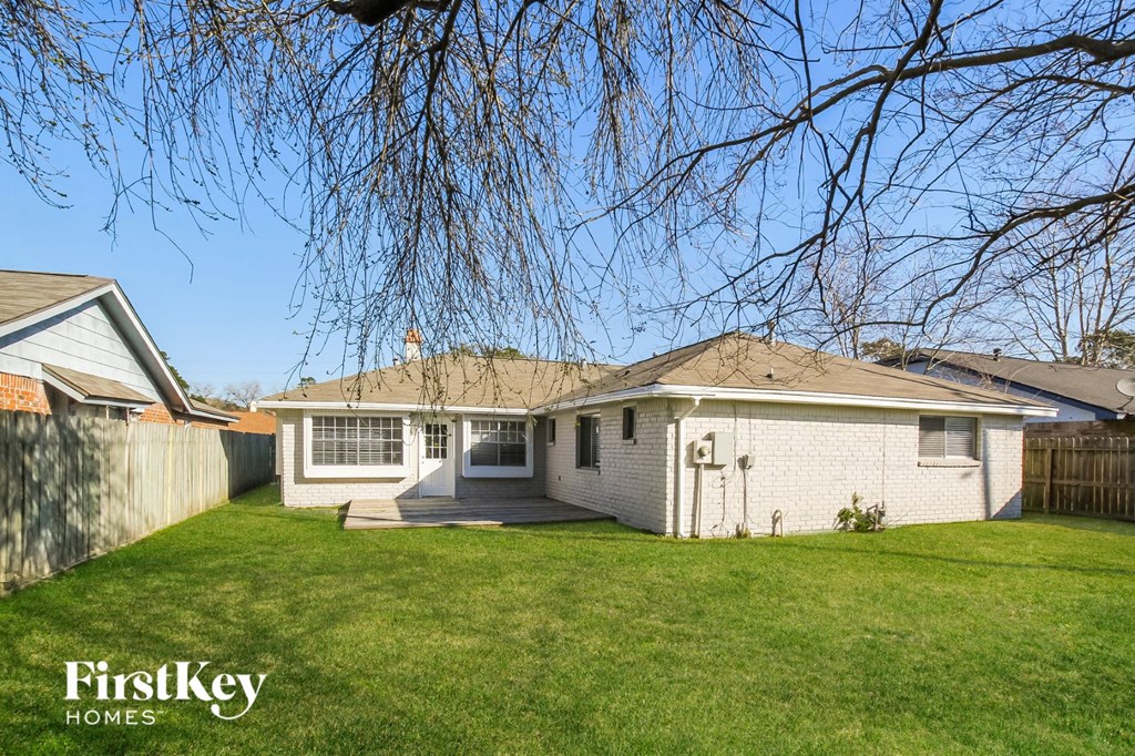 a white house with a yard and a tree