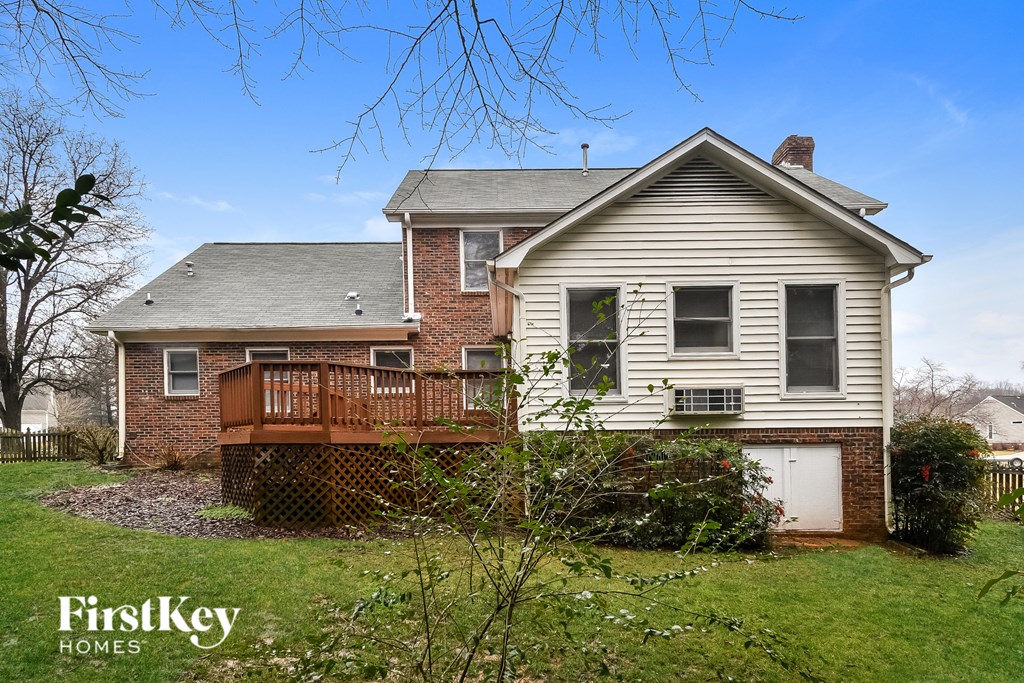 a white house with a deck and a white garage