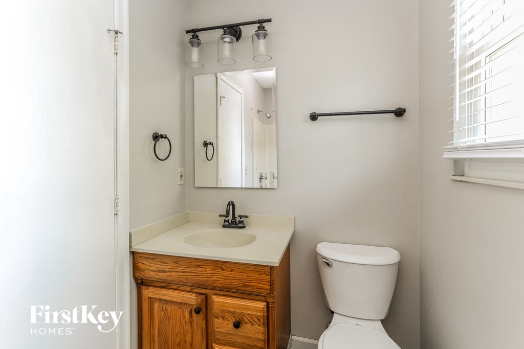 a small bathroom with a sink toilet and a mirror
