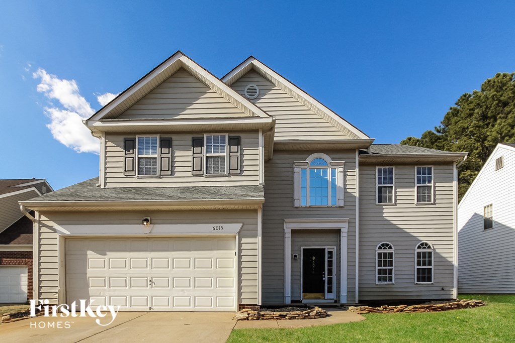 a gray house with a white garage door