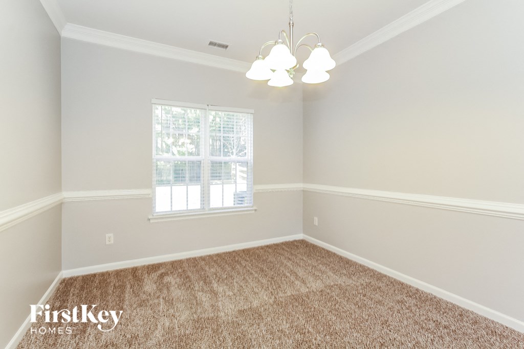 a bedroom with a carpeted floor and a window