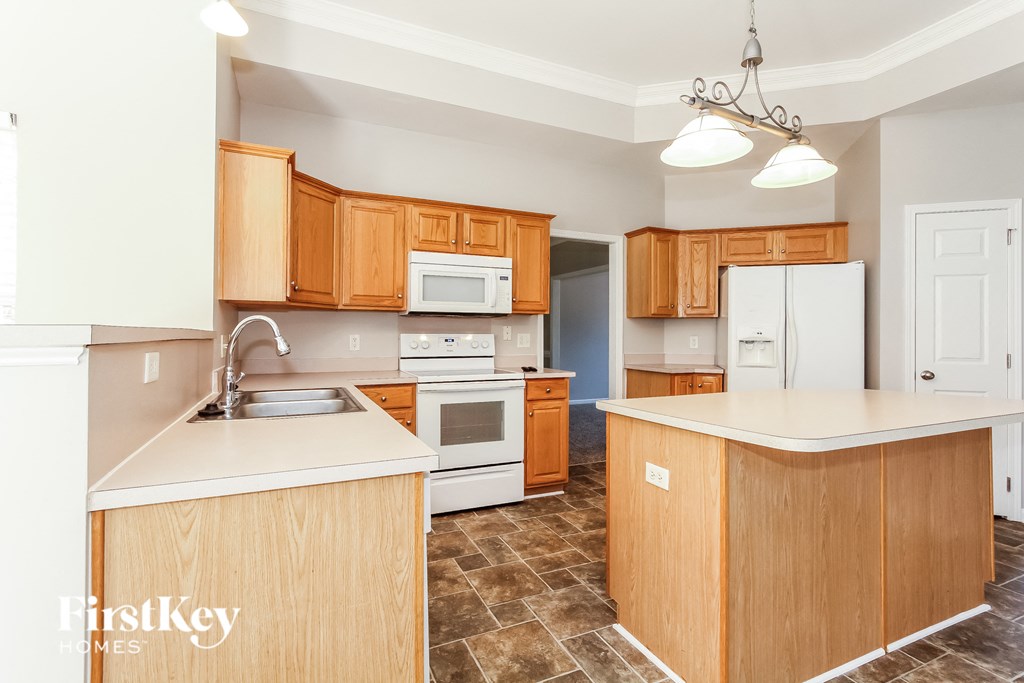 a kitchen with wooden cabinets and a white counter top