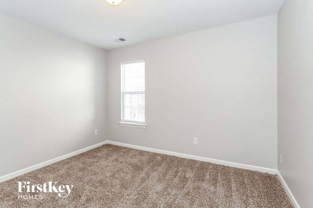 a room with a carpeted floor and a window