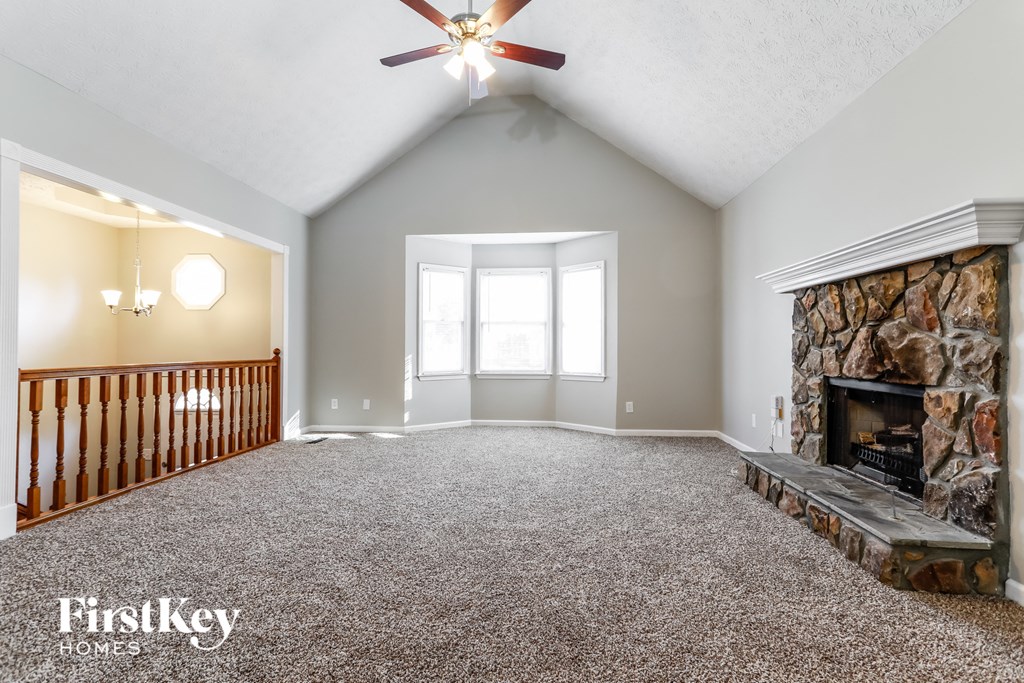 a living room with a fireplace and a carpeted floor