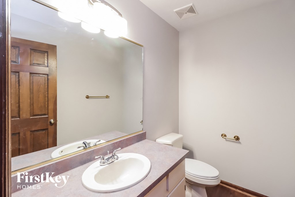 a bathroom with a sink and a toilet and a mirror