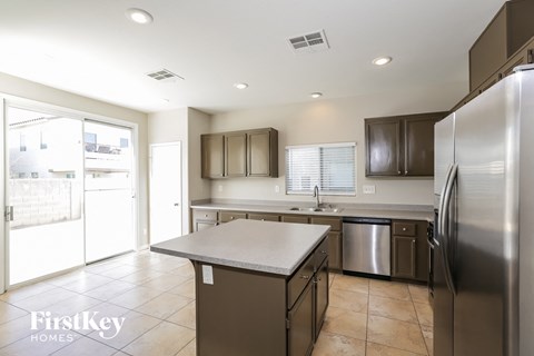 A kitchen with a stainless steel refrigerator and a countertop.