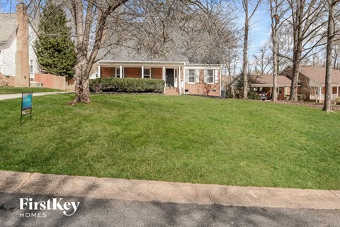 a home with a lawn in front of it and a driveway