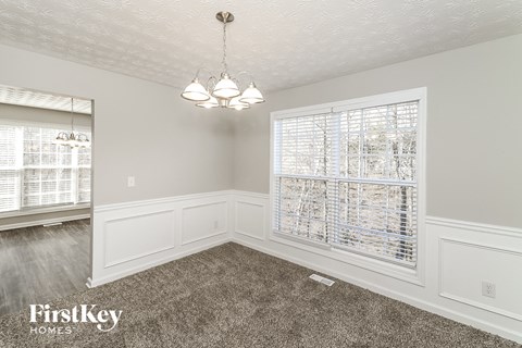 the living room of an empty home with a large window
