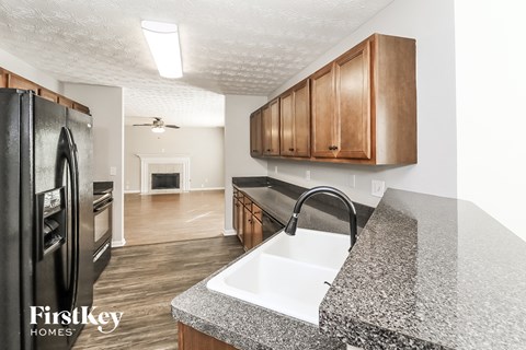 a kitchen with granite counter tops and stainless steel appliances
