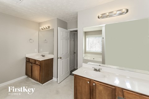 a bathroom with a sink and a mirror and a closet