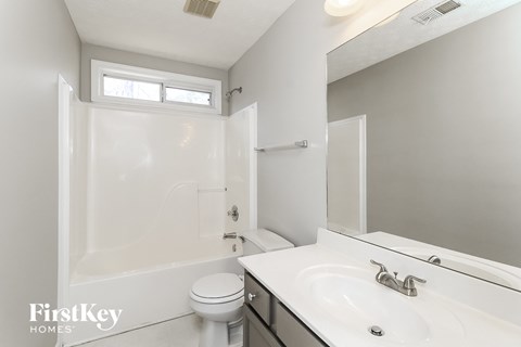 a bathroom with a sink and a toilet and a shower