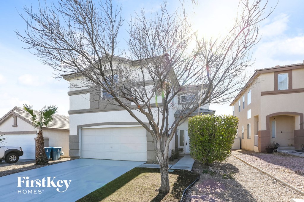 A house with a tree in front of it.