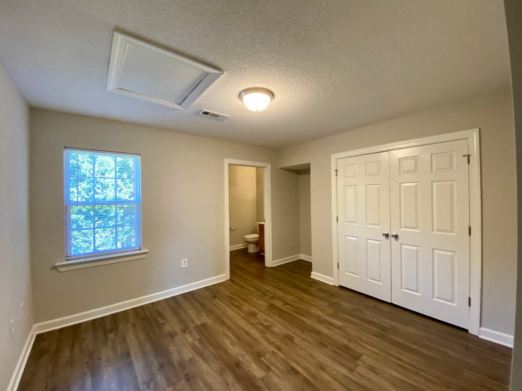 A room with a window and a door.