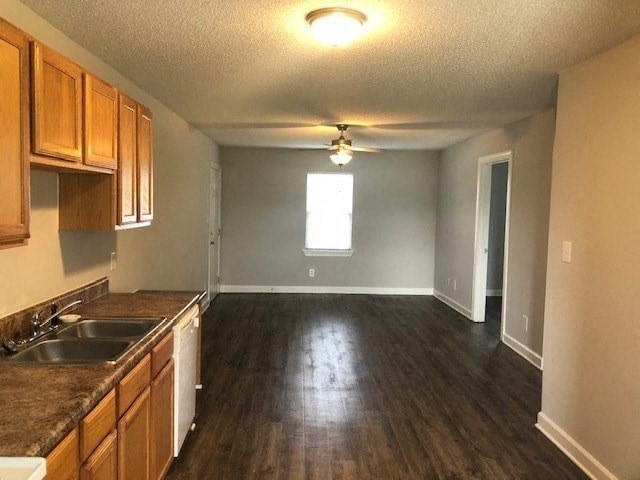 A kitchen with wooden cabinets and a sink.