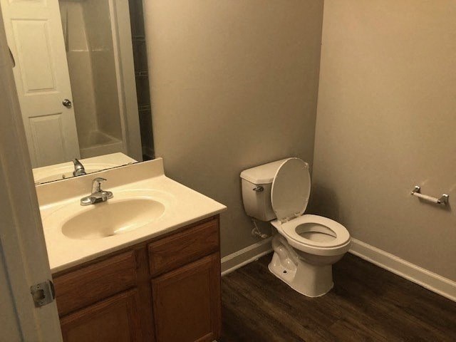 A white toilet sits next to a sink in a bathroom.