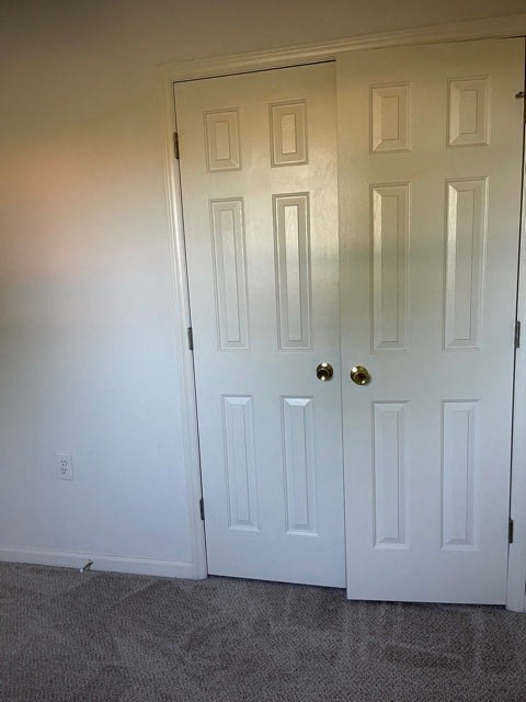 A white door with a gold handle is closed.