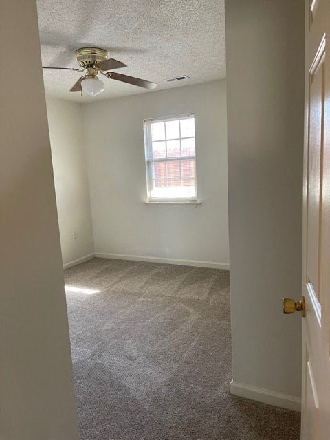 A room with a ceiling fan and a window.