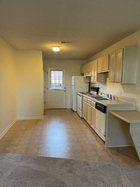 A kitchen with white cabinets and appliances.