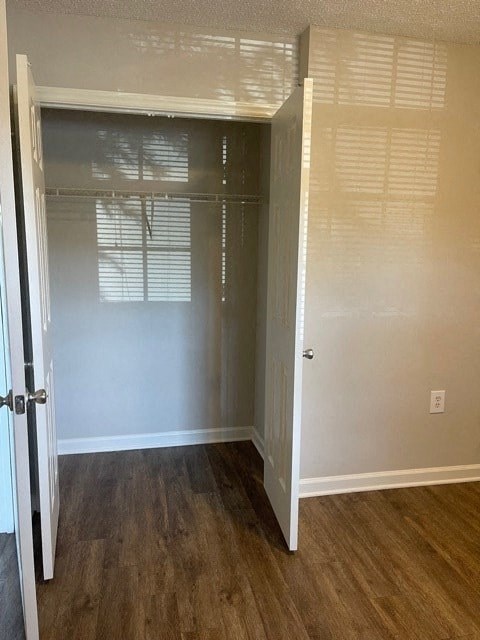 A room with a white door and a wooden floor.