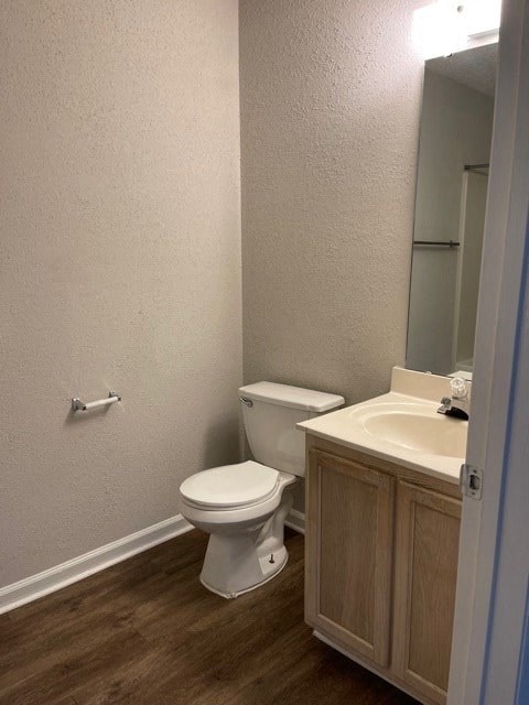 A white toilet sits next to a sink in a small bathroom.