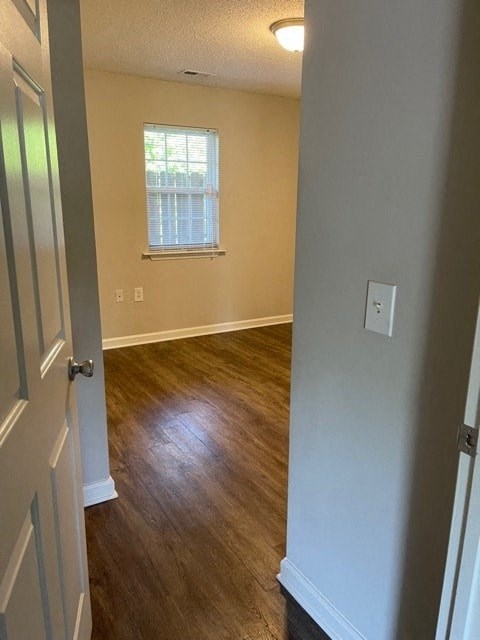 A room with a wooden floor and a window.