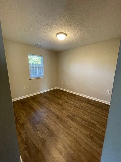A room with wooden flooring and a window.