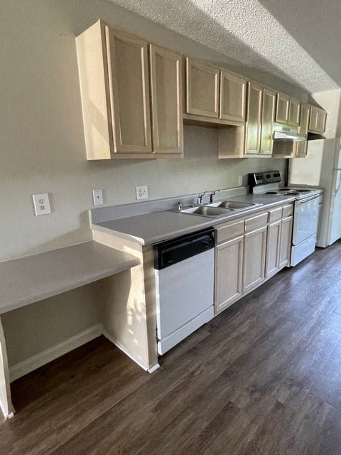 A kitchen with wooden cabinets and a white dishwasher.