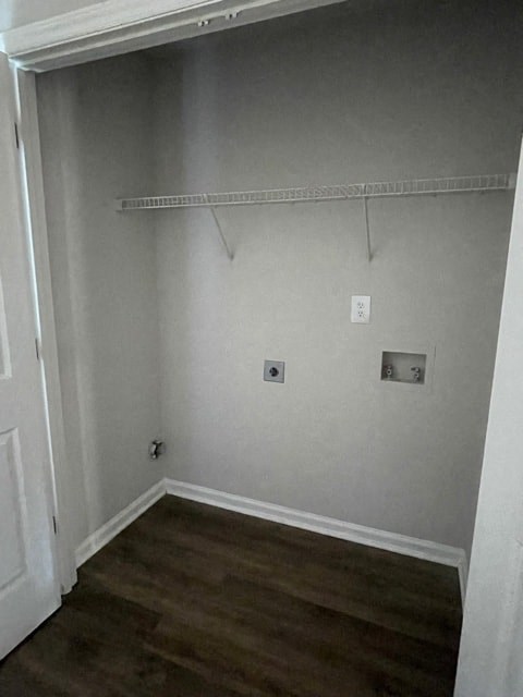 A white closet with a shelf and two electrical outlets.