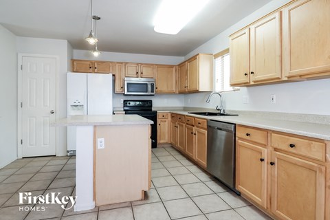 A kitchen with wooden cabinets and a white refrigerator.