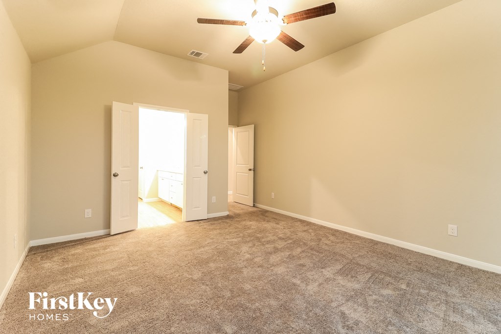 the master bedroom is spacious and has a ceiling fan