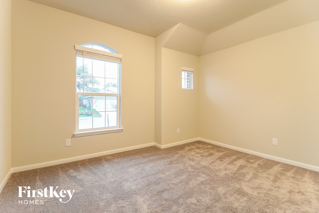 the living room of a home with carpet and a window