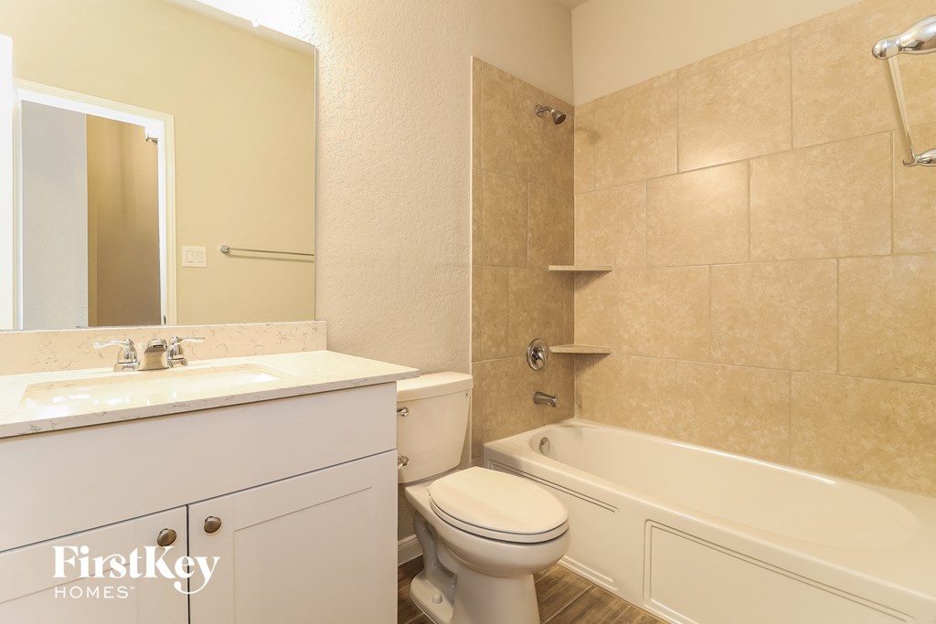 a bathroom with a sink toilet and a bath tub