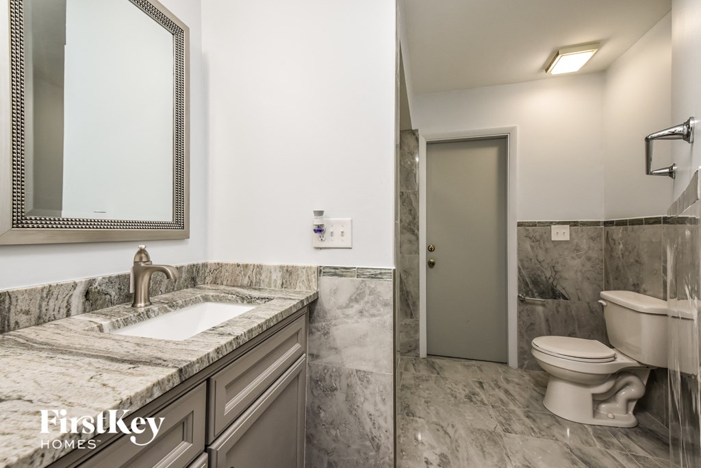 a bathroom with a sink and a toilet and a shower
