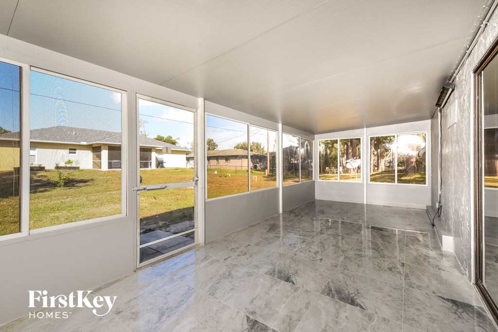 a living room with windows and a view of the yard