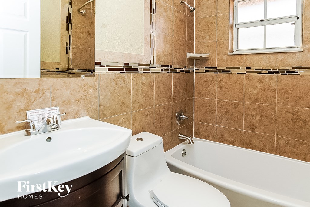 a bathroom with a sink toilet and a bath tub