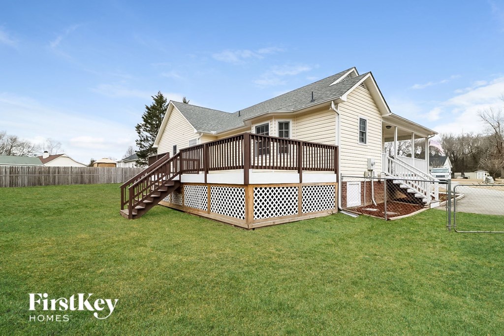 a backyard with a deck and a house