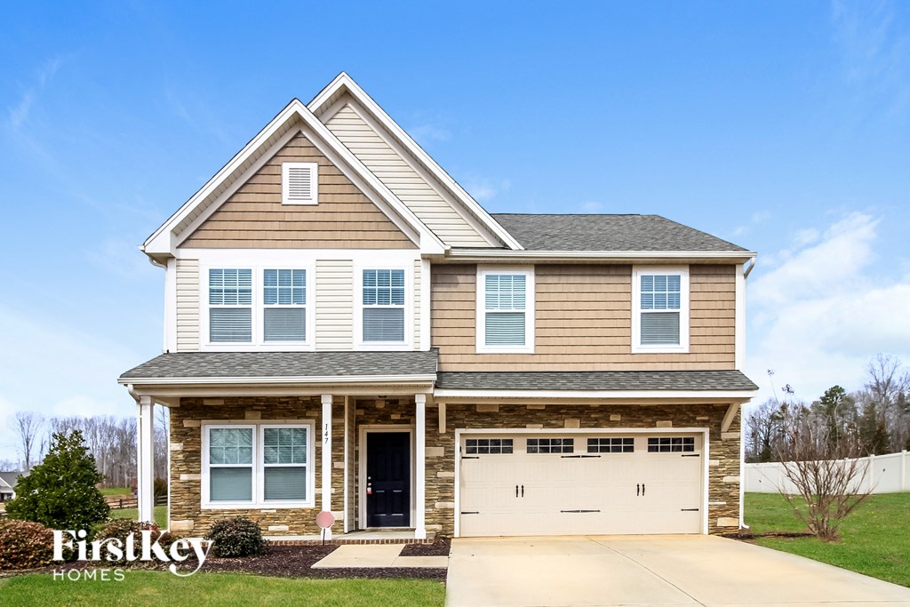A two-story house with a garage is for sale by FirstKey Homes.