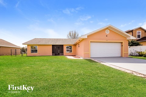 a home with a lawn and a garage door