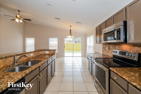 a kitchen with granite counter tops and stainless steel appliances