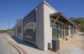 A building with a sign that says "Bust Stop Cafe".