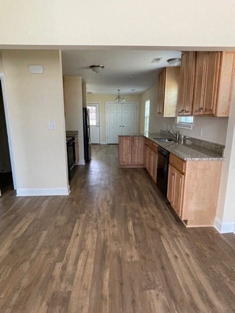 A kitchen with wooden floors and cabinets.